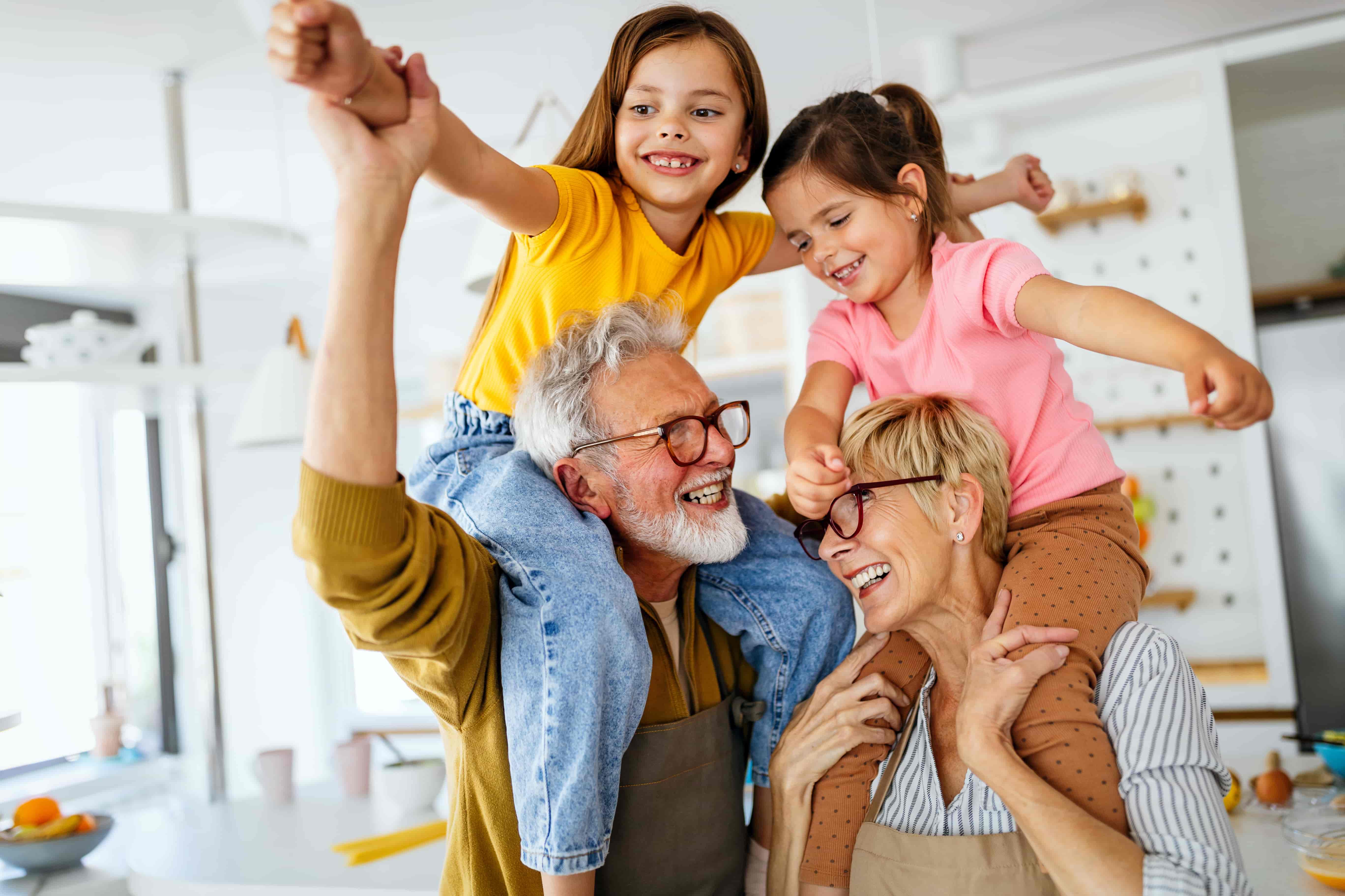 Grandparents carrying their grandchildren