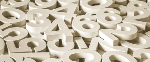 A scattered pile of large white 3D numbers overlapping one another.